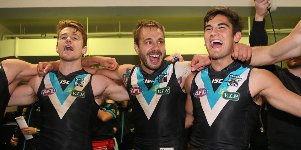 Robbie Gray, Tom Logan and Chad Wingard celebrate