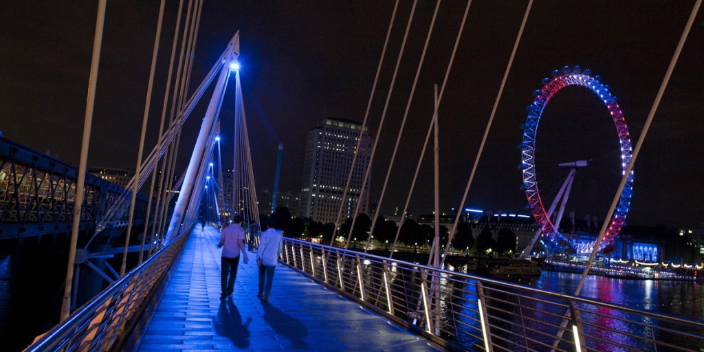 The London Eye and Golden Jubilee Bridge are illuminated in celebration of the birth of a royal baby boy. Photo: AFP