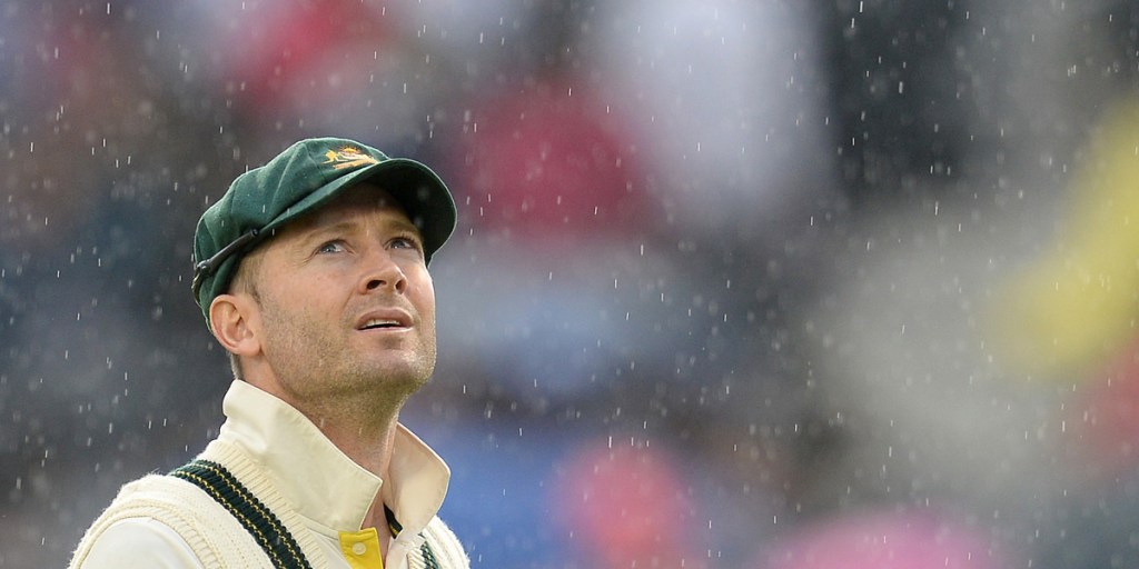 Michael Clarke looks skyward as rain stops play in the third Ashes test at Old Trafford.