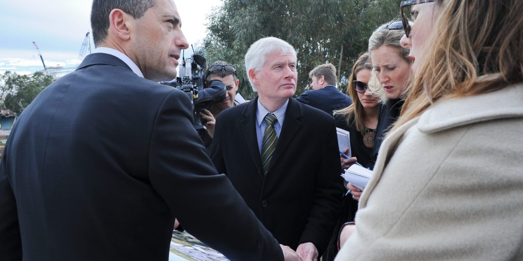 Planning Minister John Rau (centre) with ministerial colleague Tom Koutsantonis (left) and members of the media.