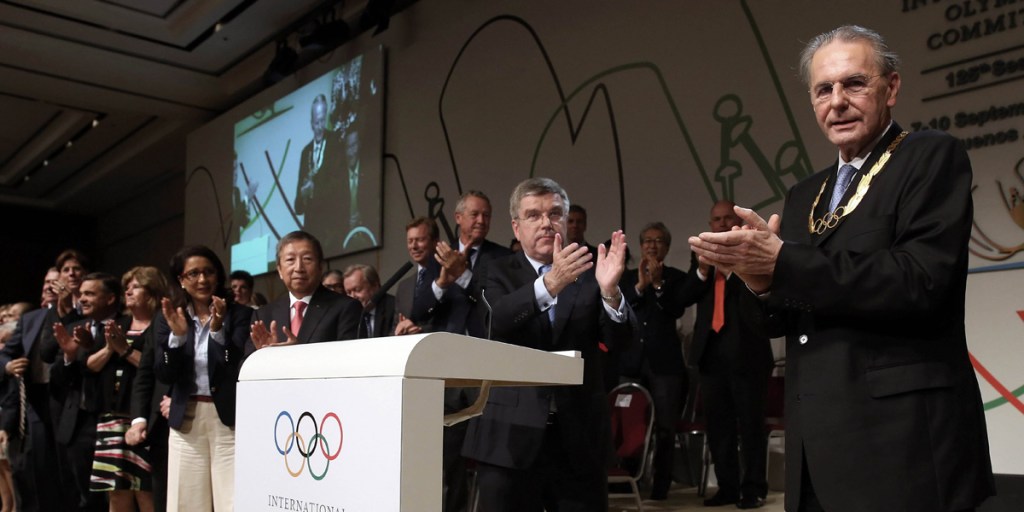 Bach's first duty was to present the Olympic order to predecessor Jacques Rogge
