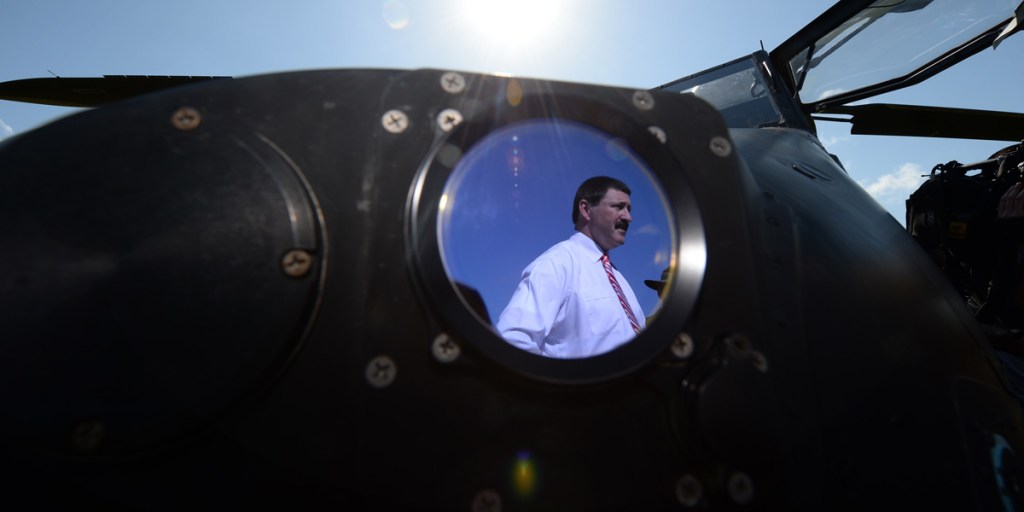 Former Minister for Defence Material Mike Kelly - pictured reflected in a Tiger attack helicopter - has conceded defeat in Eden-Monaro.