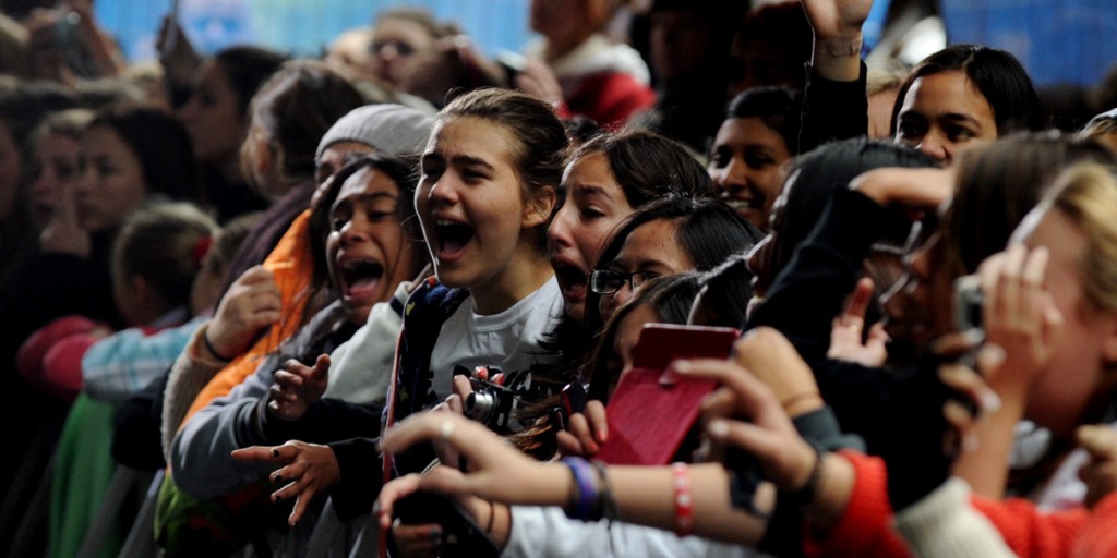 Think of what we missed: One Direction fans try to catch a glimpse of the band in Sydney.
