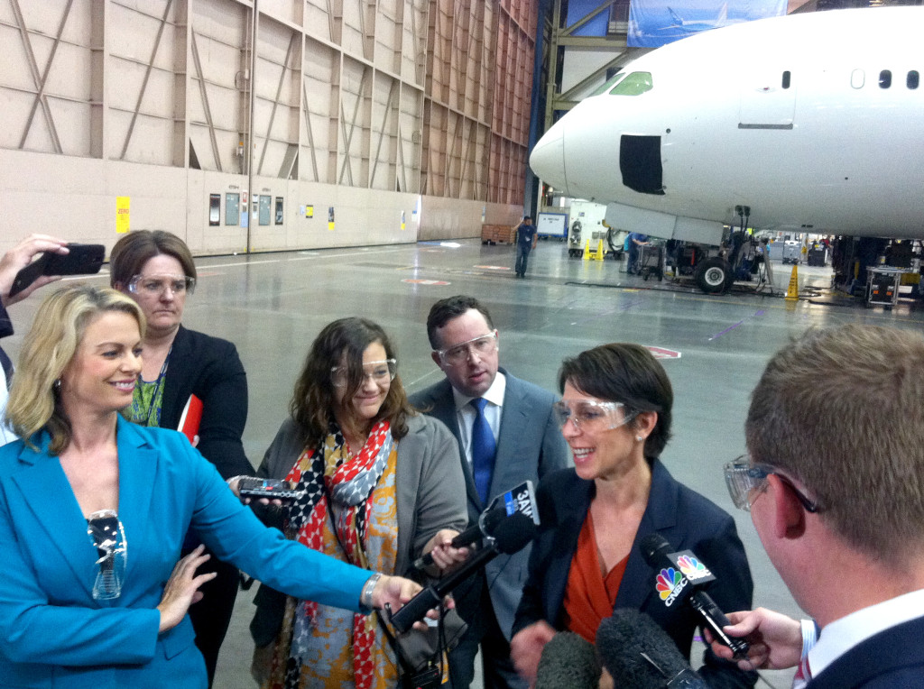 With Qantas boss Alan Joyce looking on, Jetstar CEO Jayne Hrdlicka addresses media at the Boeing factory in Seattle,