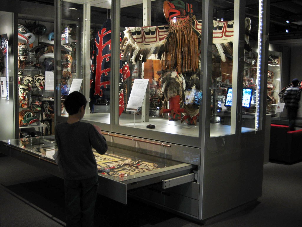 A child opening a drawer to view exhibits at the Multiversity Gallery, UBC Museum of Anthropology, in Vancouver, Canada.


