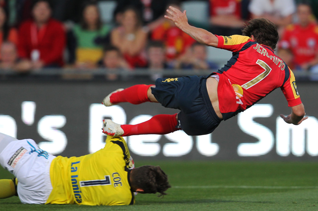 Adelaide's Jeronimo Neumann is taken down by Melbourne's Nathan Coe and awarded a penalty