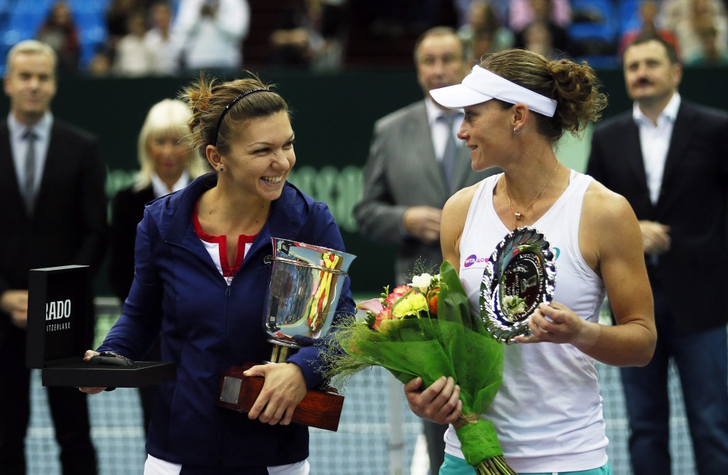 Simona Halep (L) of Romania holds her trophy after beating Samantha Stosur (R) of Australia in the final in Moscow