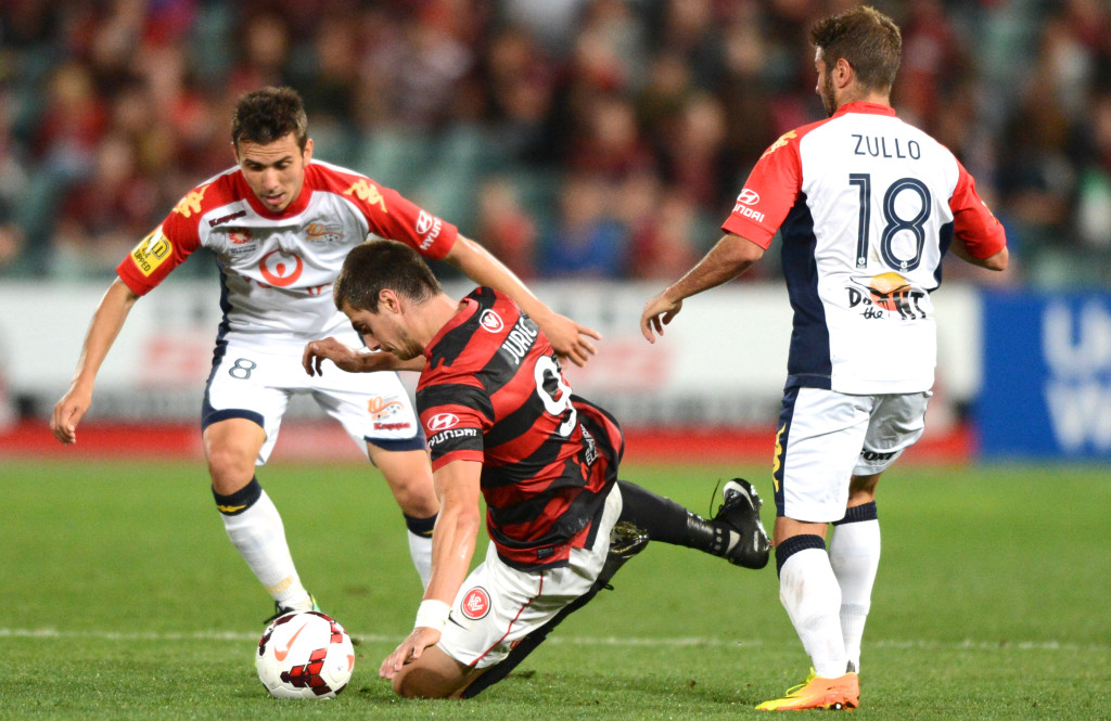 Wanderer's Tomi Juric is tackled by United's Isaias and Michael Zullo