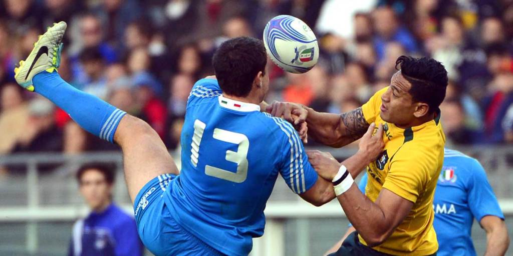Australia's full back Israel Folau (right) vies for the ball with Italy's center Luca Morisi during Australia's demolition of Italy in their rugby test match in Turin.

