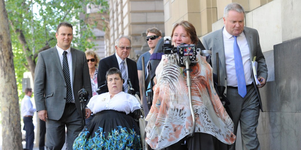 Thalidomide survivors Lynette Rowe and Monica Mcghie leave the Melbourne Supreme Court this morning with family and lawyers. Photo: AAP