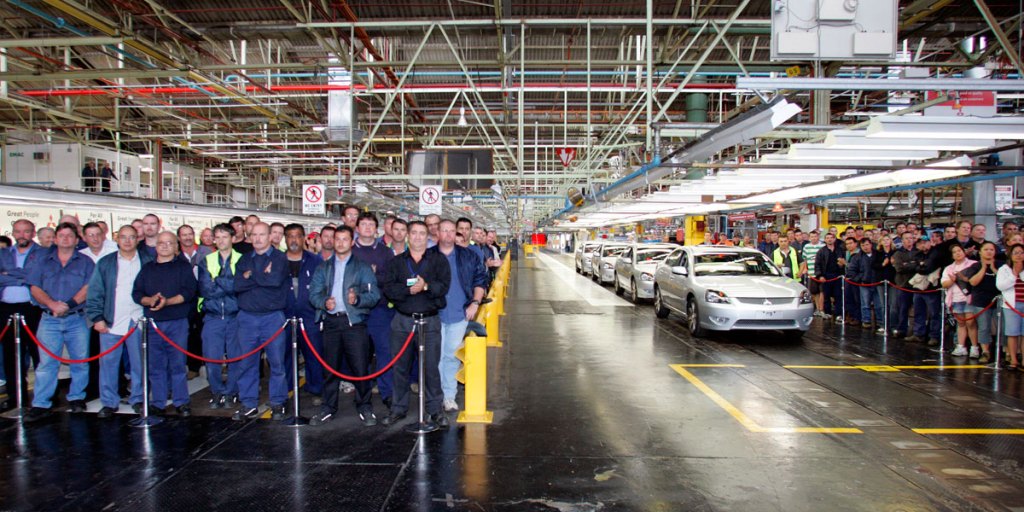 Mitsubishi workers with the last four cars to leave the factory's assembly line the day before the closure of the Tonsley Park factory in Adelaide in 2008.