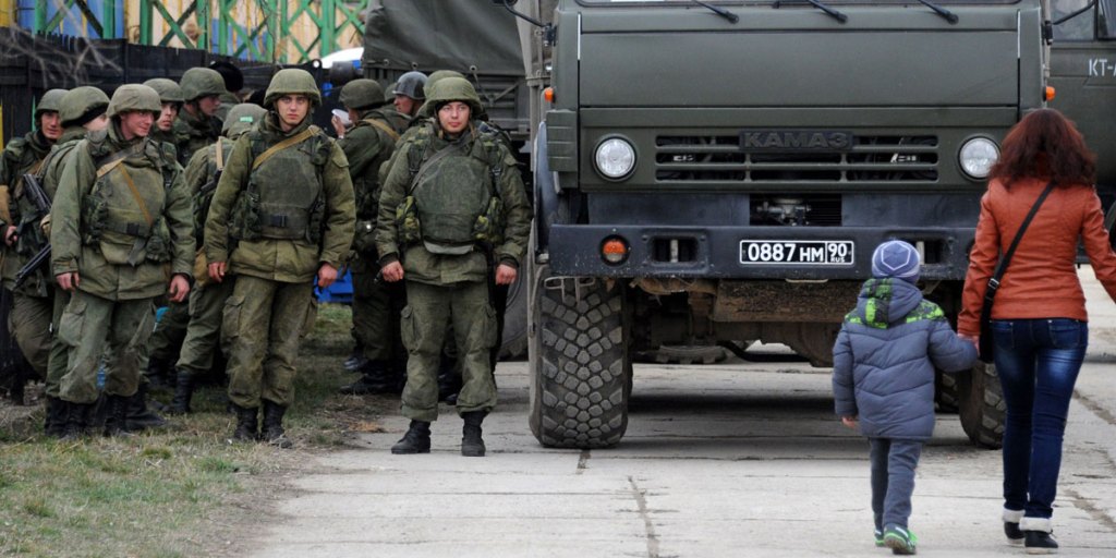Military personnel stand near a Russian-made Kamaz truck in the eastern Crimea'a port city of Feodosiya on March 2.