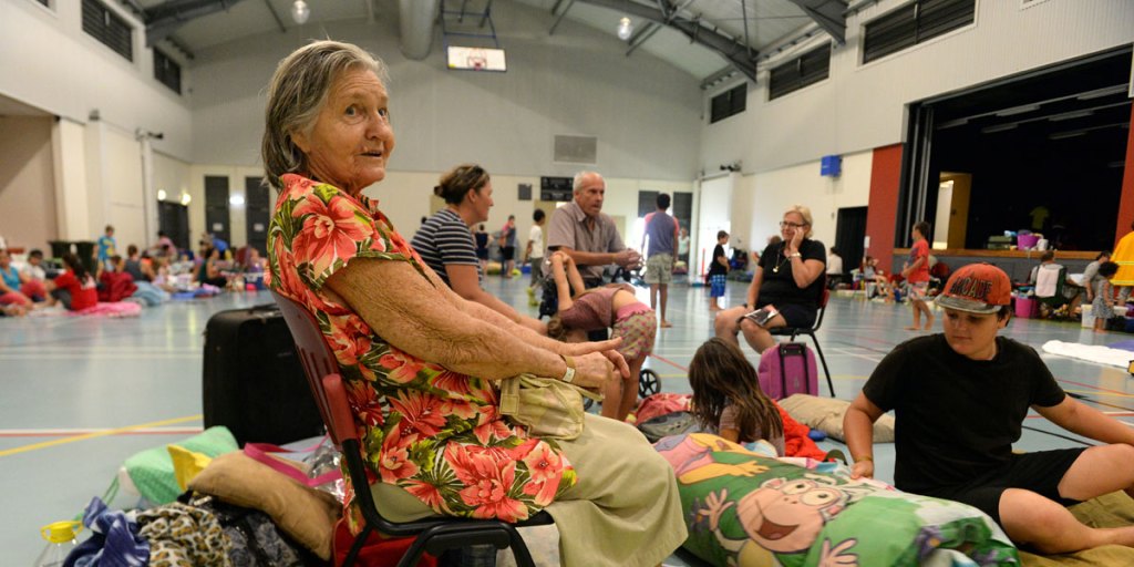 Eighty-six-year-old Win Bass and her family take shelter in the evacuation centre in Cooktown today.