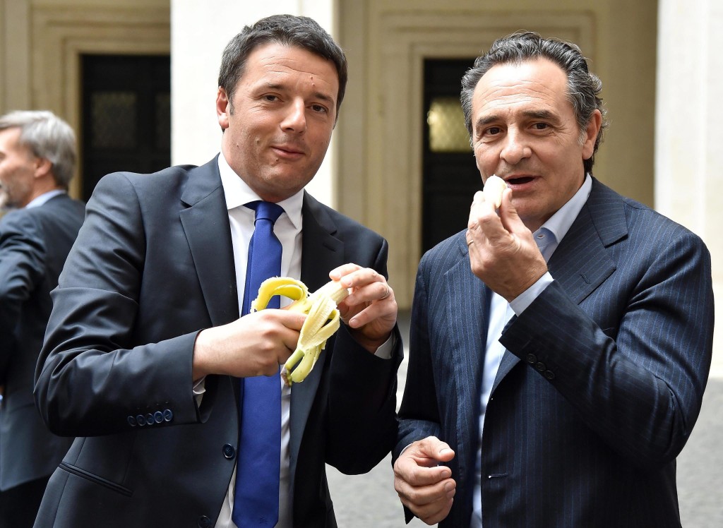 Italian Prime Minister Matteo Renzi (L) and Italy's national soccer coach Cesare Prandelli giving a symbolic demonstration of solidarity against racism in soccer.
