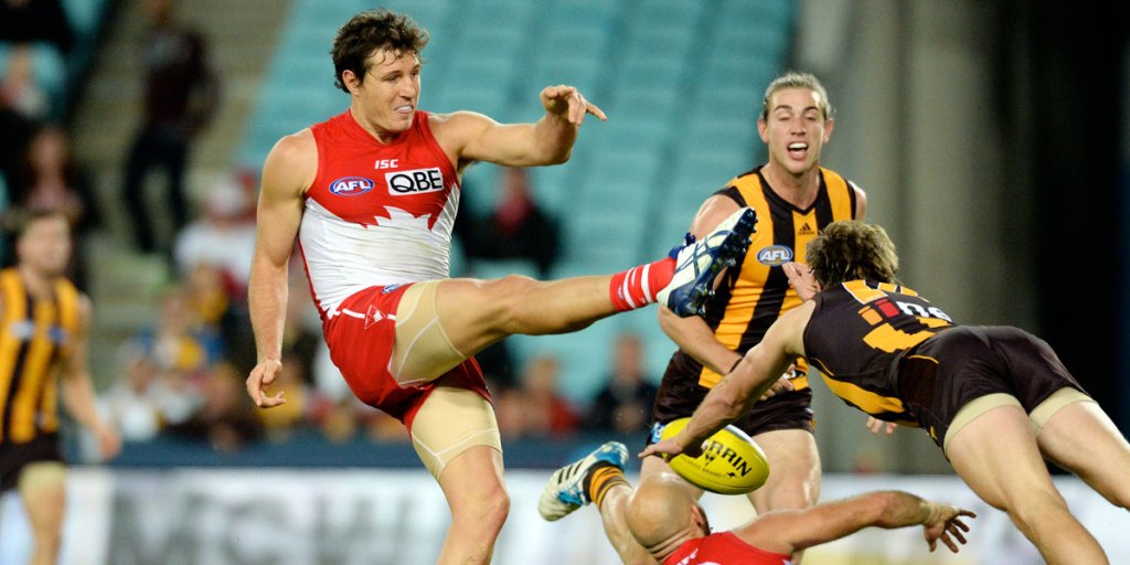 An unnamed, but vaguely familiar, Swans player fluffs a kick against the Hawks.