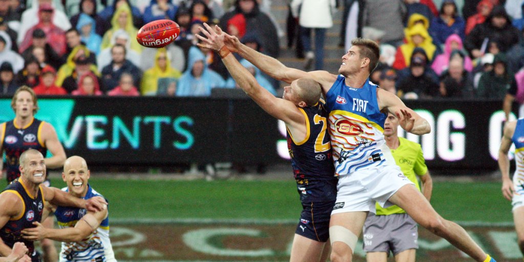 Crows ruckman Sam Jacobs battles the Suns' Zac Smith. Photo: Peter Argent