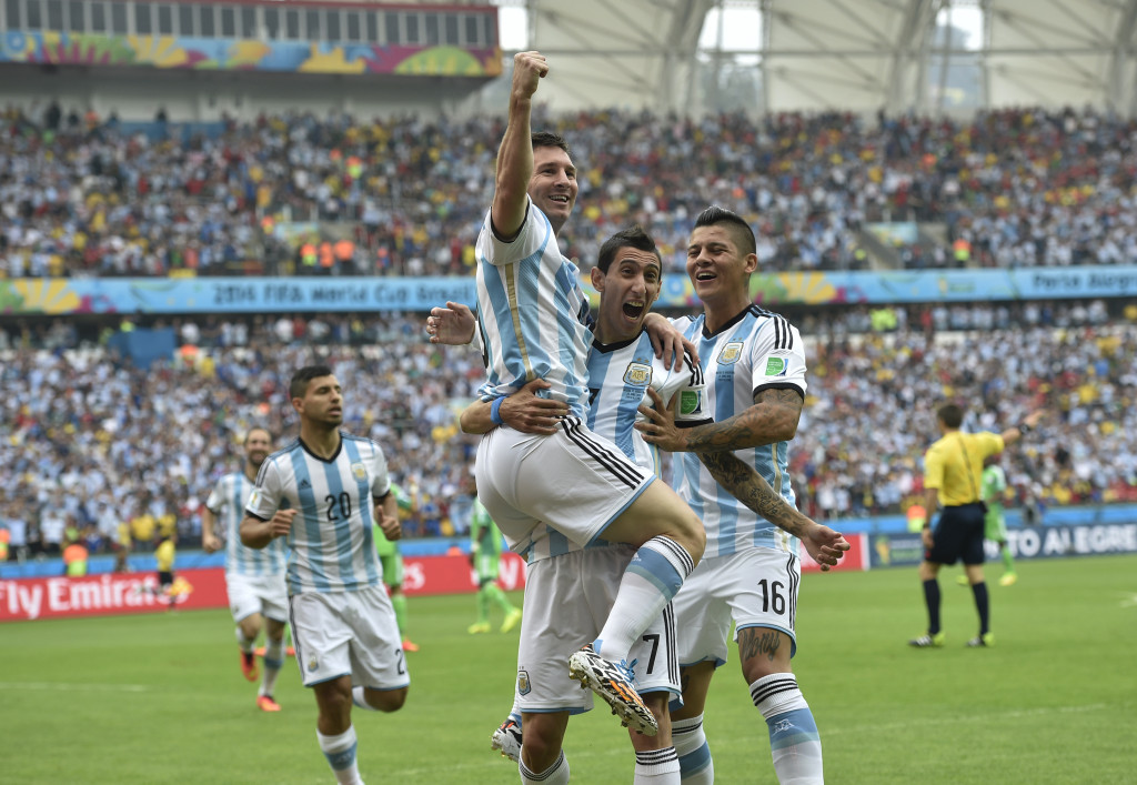 Lionel Messi, carried by his teammates Angel di Maria (7) and Marcos Rojo