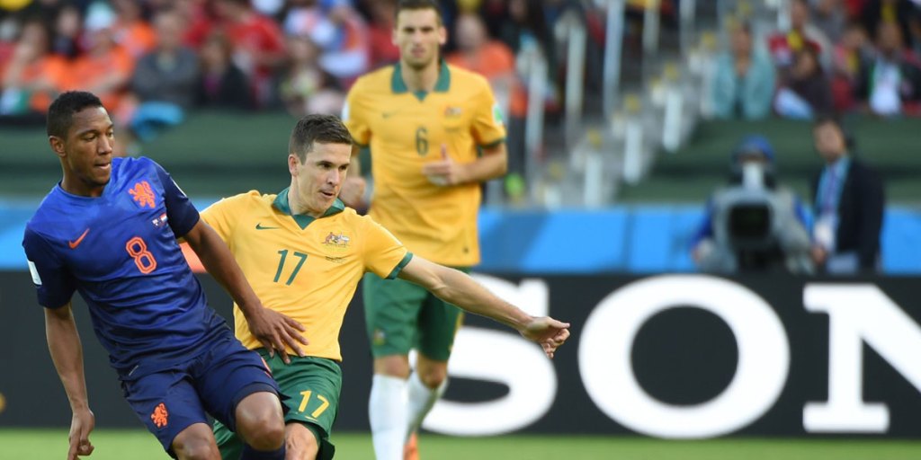 Australia's midfielder Matt McKay battles the Netherlands' Jonathan de Guzman.