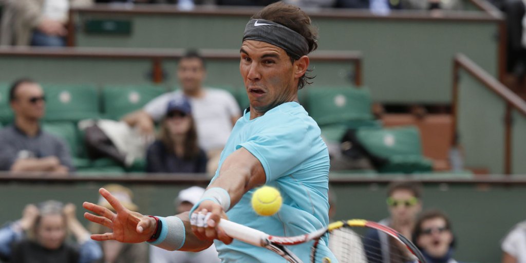 Spain's Rafael Nadal returns the ball to Serbia's Dusan Lajovic.