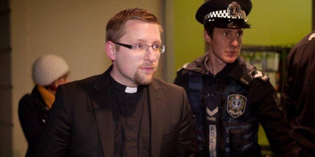 Reverend John Hughes being arrested last night. 