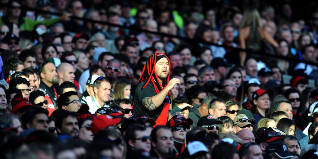 A lone Essendon fan explains his feelings to the umpire at the MCG.