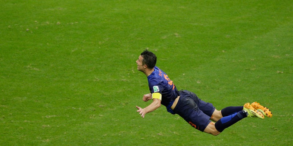 Robin van Persie in the midst of completing a headed goal against Spain.