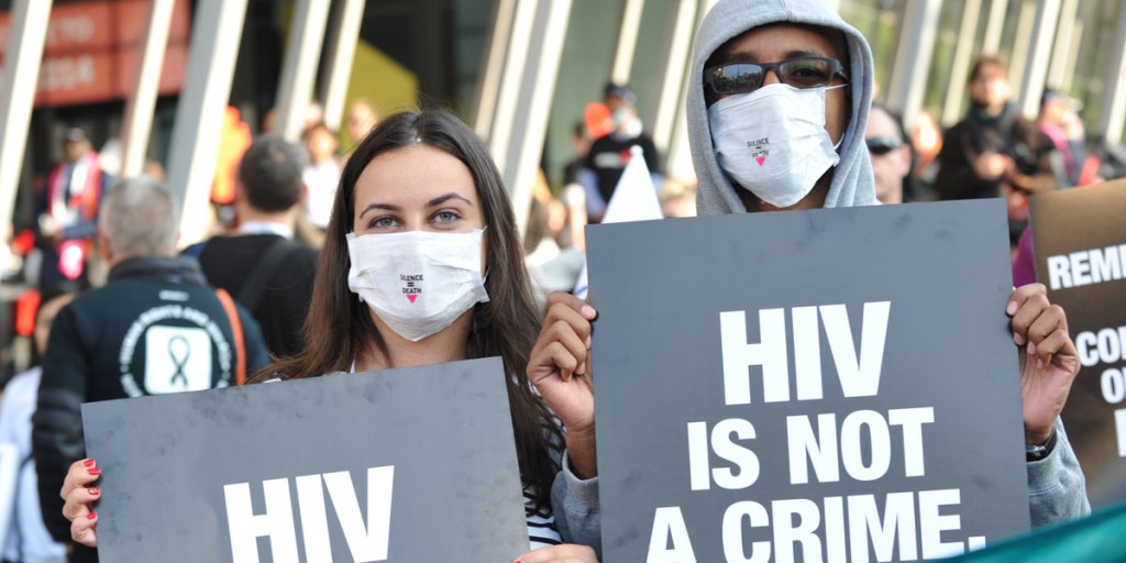 Activists display placards during a rally at the AIDS Conference in Melbourne. Photo: AFP