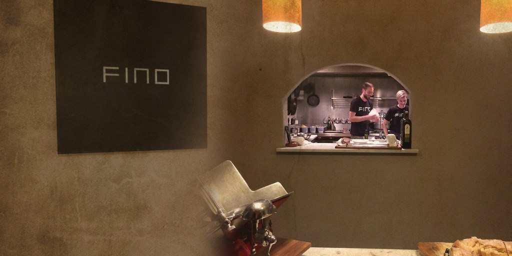 A mash-up of Fino's understated entrance sign, and the theatrical window into a very calm kitchen.