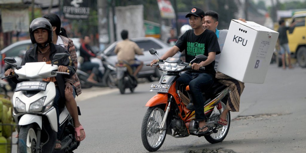 Indonesian election officers deliver ballot boxes to remote areas, one day ahead of presidential elections in Tanggerang, Banten.