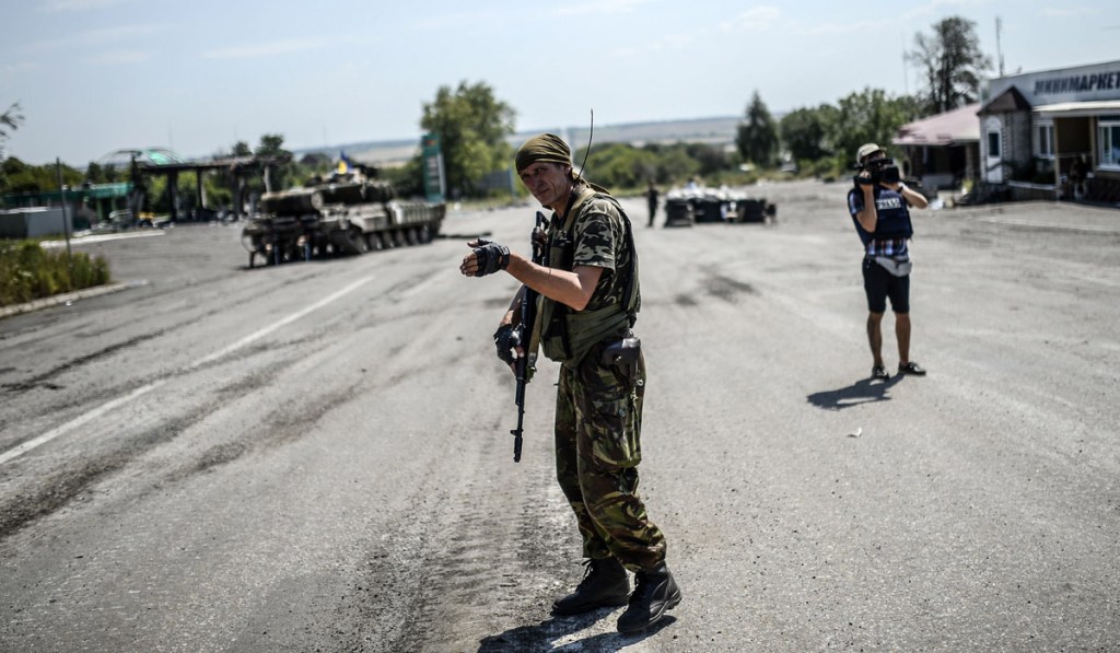 A Ukrainian soldier controls traffic at a check-point in eastern Ukraine. Photo: AFP