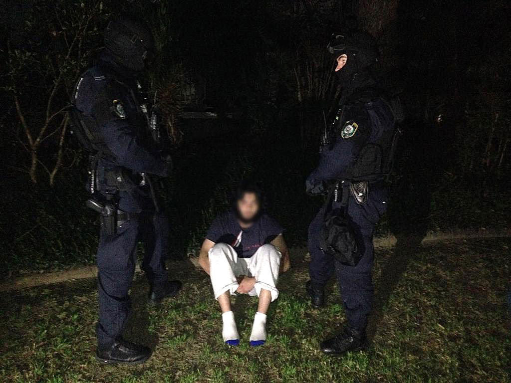 A man arrested following the execution of search warrants across Sydney's north-west suburbs, Thursday, Sept. 18, 2014.