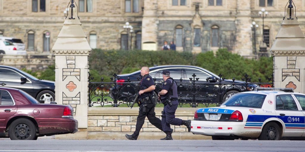 Emergency responders attempt to secure a portion of downtown Ottawa near Parliament Hill after the shooting.
