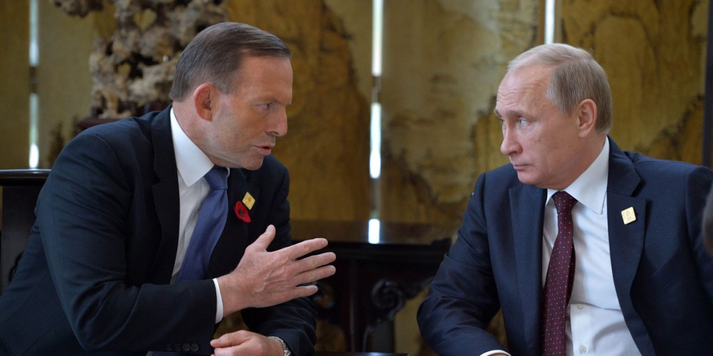 Russian President Vladimir Putin (R) speaks with Australia's Prime Minister Tony Abbott before the APEC summit in Beijing.
