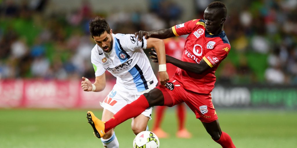 Melbourne City's on-loan star David Villa is tackled by Reds' young gun Awer Mabil during Friday night's game.