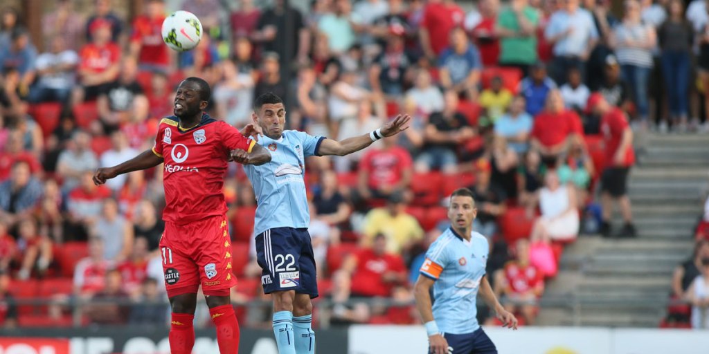 Reds' danger man Bruce Djite jumps for a header before coming off injured against Sydney FC.