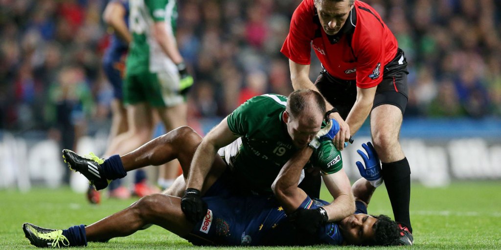 Ireland's Ciaran McKeever and Australia's Alwyn Davey tussle during the International Rules Series match in Dublin in 2013.