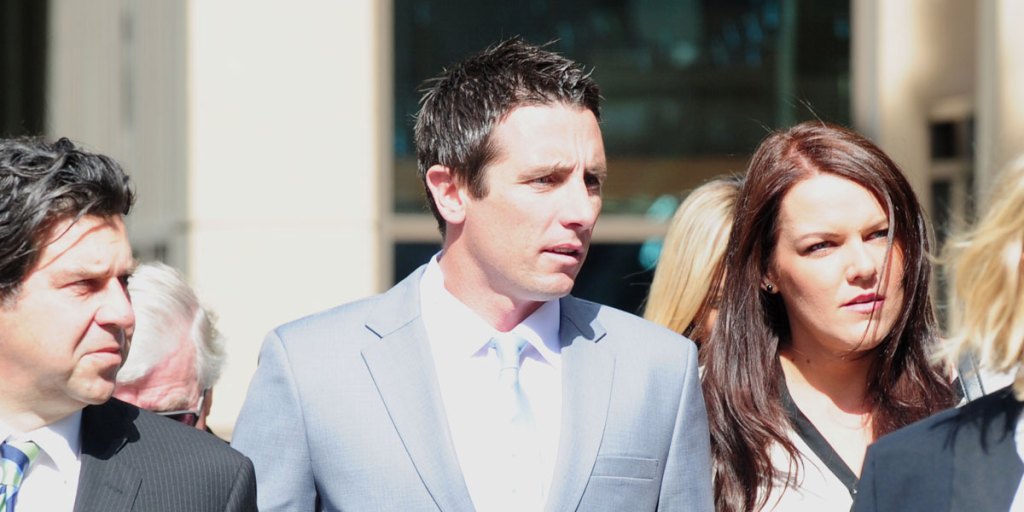 Former St Kilda star Stephen Milne (centre) arrives at court today.