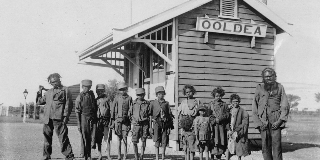 Aboriginal men and children outside the Ooldea post office, circa 1920. Photo: State Library of South Australia