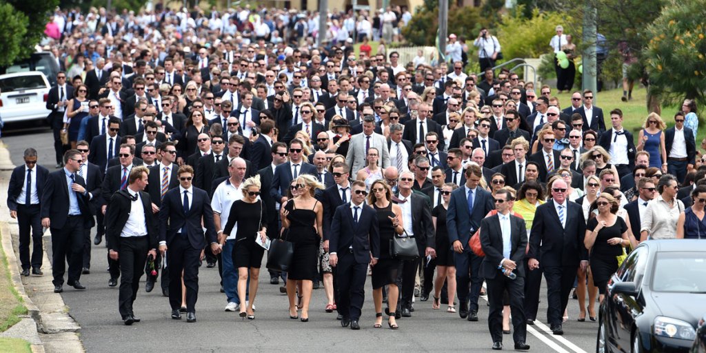 Mourners, including many past and present Australian cricketers, walk down Wallace St, Macksville, after Phillip Hughes' funeral.