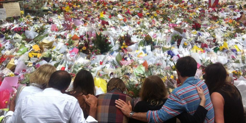 Mourners gather at the ever-growing floral tribute in Martin Place.