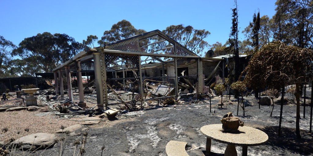 A gutted home in the fire zone. AAP image