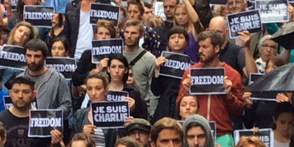 Attendees hold "Je Suis Charlie" signs during a solidarity rally in Martin Place, Sydney.
