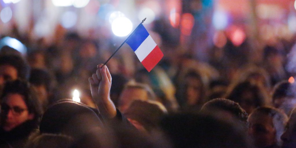 Parisians gather to show their respect to the 12 people killed in an attack on newspaper Charlie Hebdo.