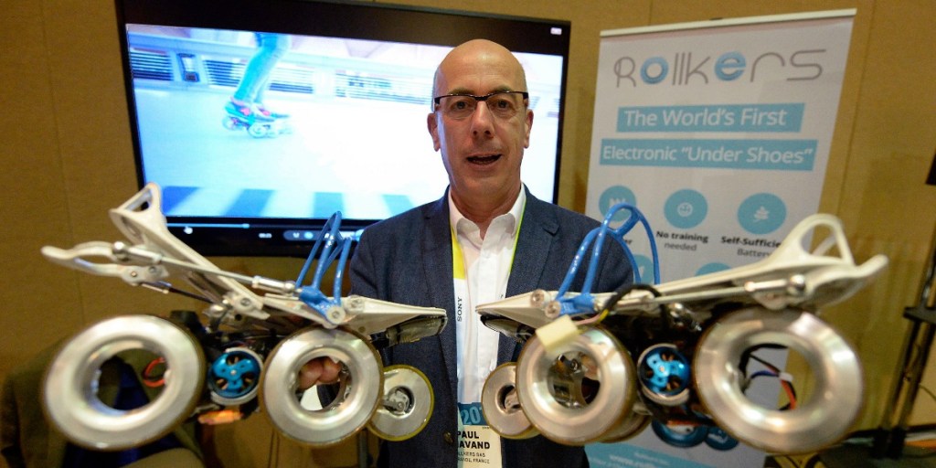 Rollkers CEO Paul Chavand shows off the 'Under Shoe', which allows pedestrians to be automatically propelled along the street.