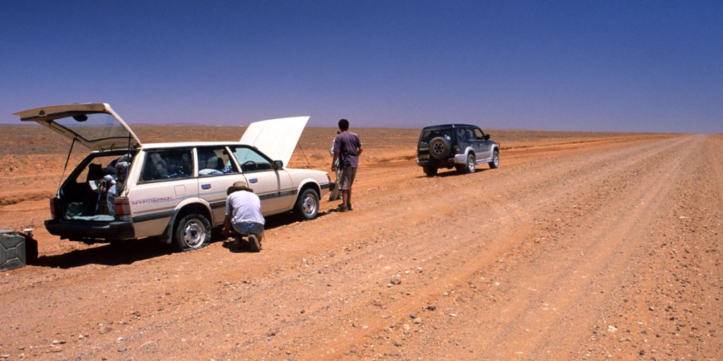 A desert traveller changes a blown tyre near Mount Hopeless on the unforgiving Strzelecki Track. 