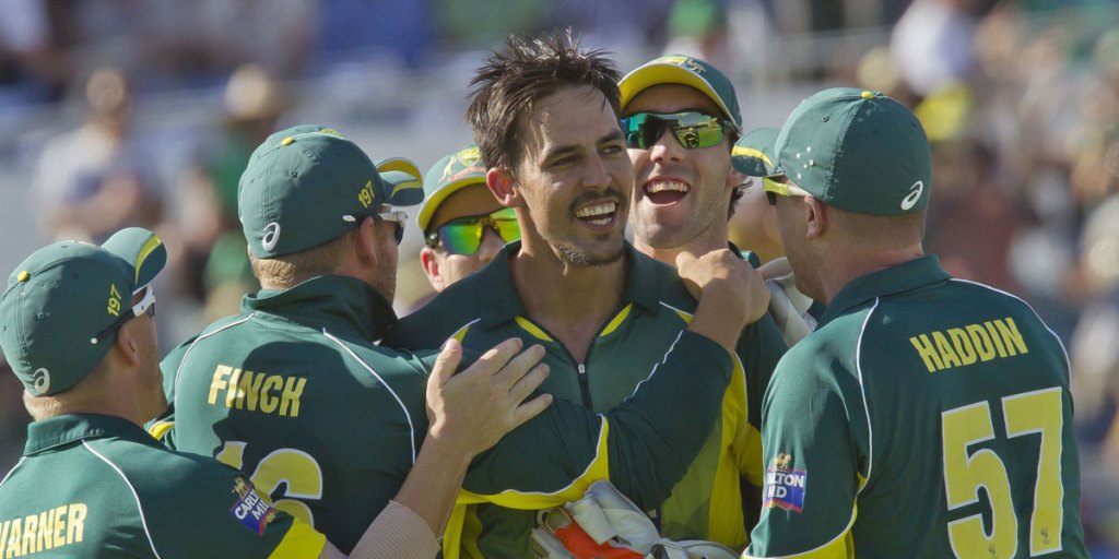 MItchell Johnson is mobbed by teammates after dismissing England captain Eoin Morgan.
