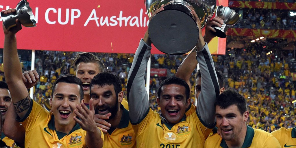 Tim Cahill holds up the AFC Asian Cup trophy after beating South Korea in the final.