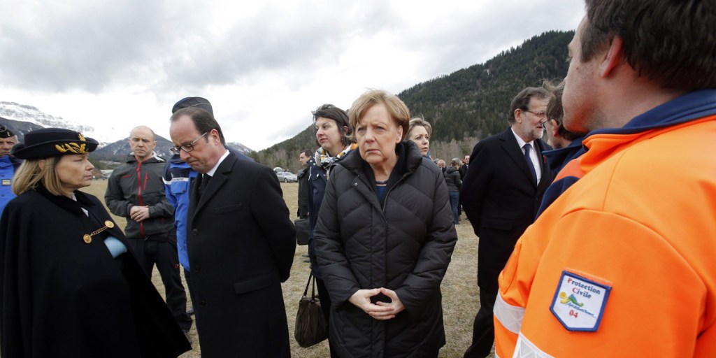 French President Francois Hollande, German Chancellor Angela Merkel and Spanish Prime Minister Mariano Rajoy speak with rescue workers at the crash site. Photo: AAP