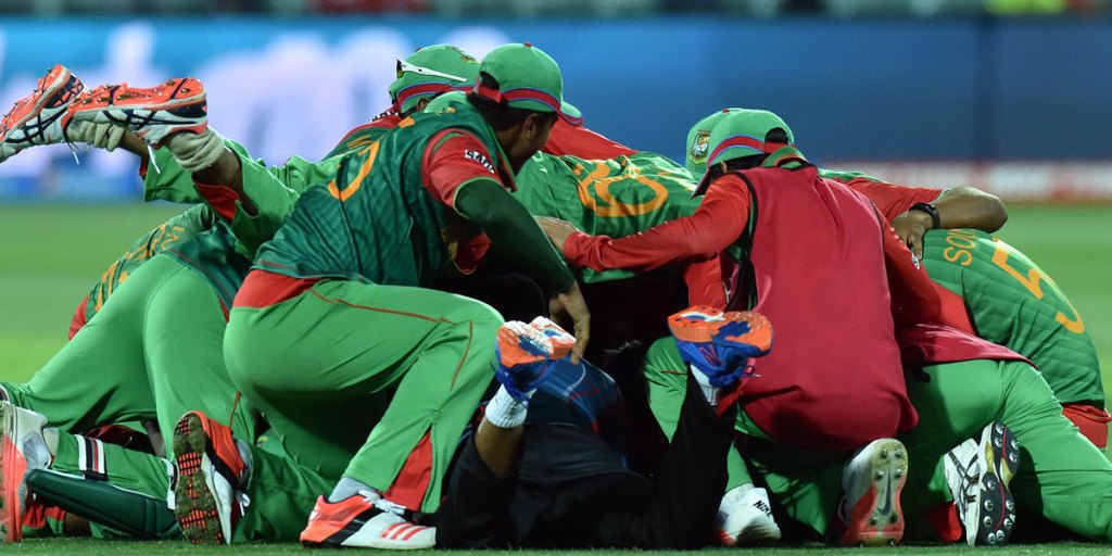 Jubilant Bangladesh players celebrate their victory over England at Adelaide Oval.