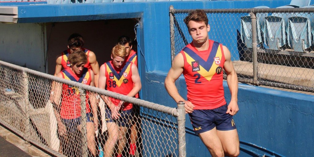 Will Snelling leads his state under 18 teammates onto the ground.